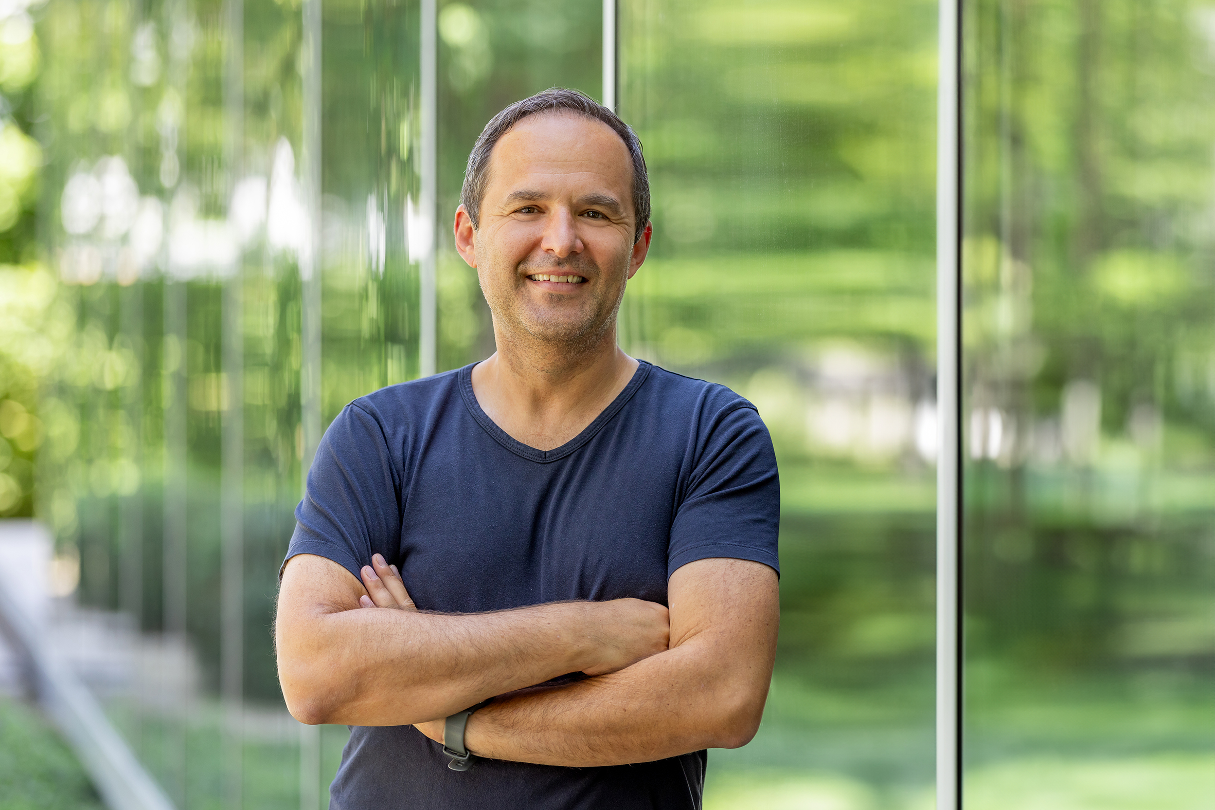 ESB Mitarbeiter vor Glasfenster mit Bäumen im Hintergrund