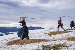 Drei Personen stehen mit Peitschen im Schnee. Die Apernschnalzer sind ein Brauchtum in Oberbayern.